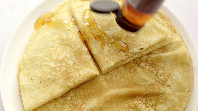 healthy crepes on a plate with shiny syrup