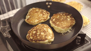 Golden pancake flipping in non-stick skillet