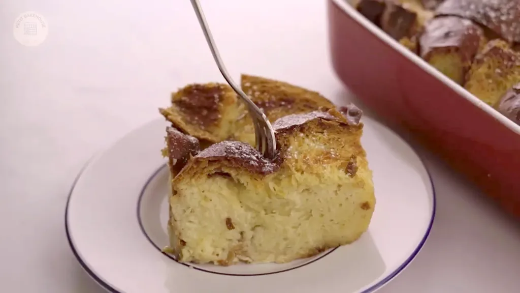 Angled close-up of golden, crackly crust with creamy layers underneath