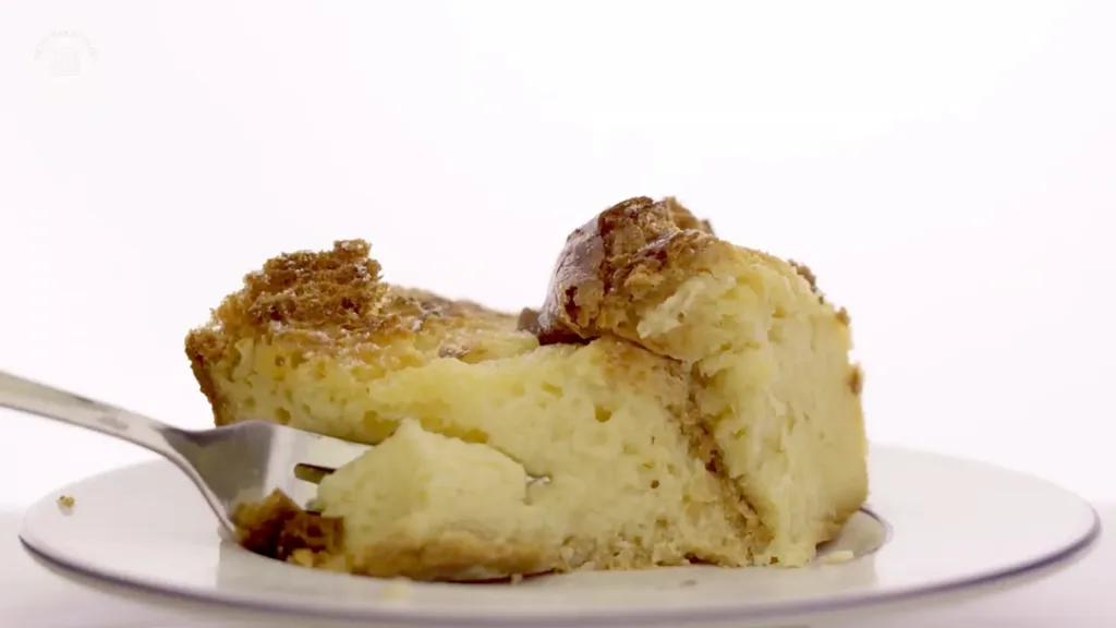 Angled close-up of golden, crackly crust with creamy layers underneath