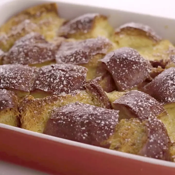 Overhead view of bread pudding in a red baking dish